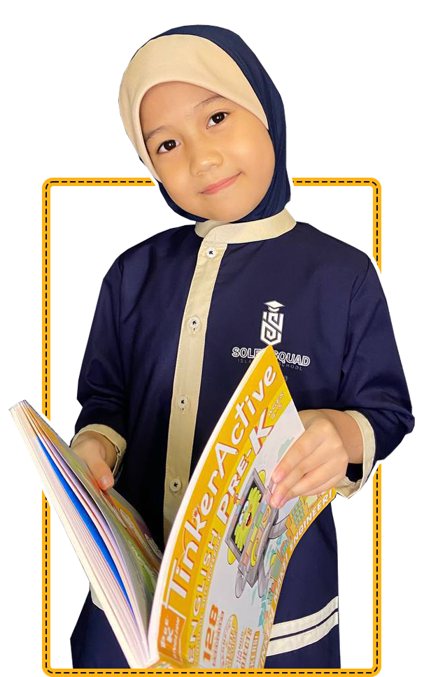 A Soleh Squad preschooler holding a workbook